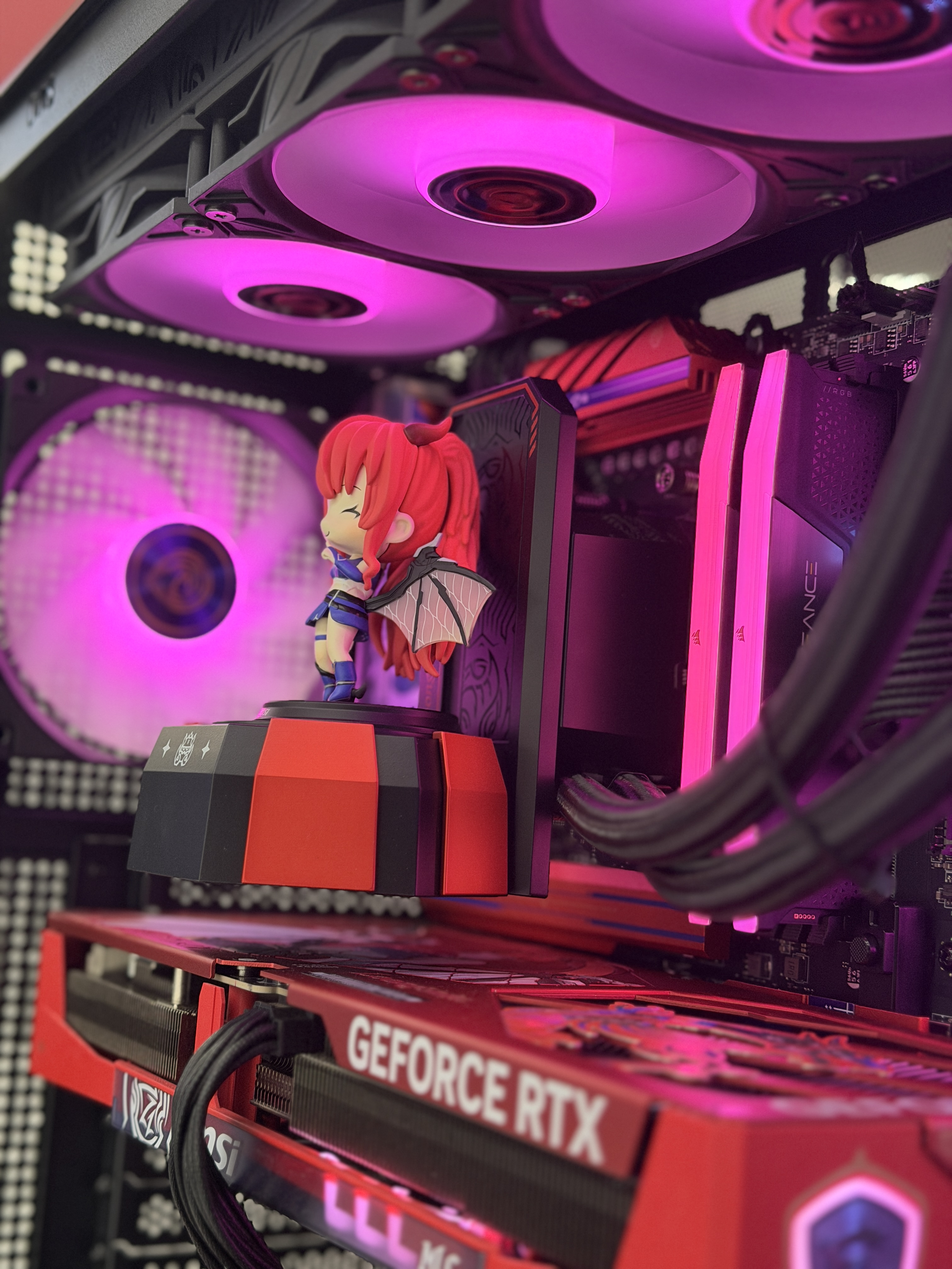 Close-up of a collectible figure and graphics card inside a custom gaming PC