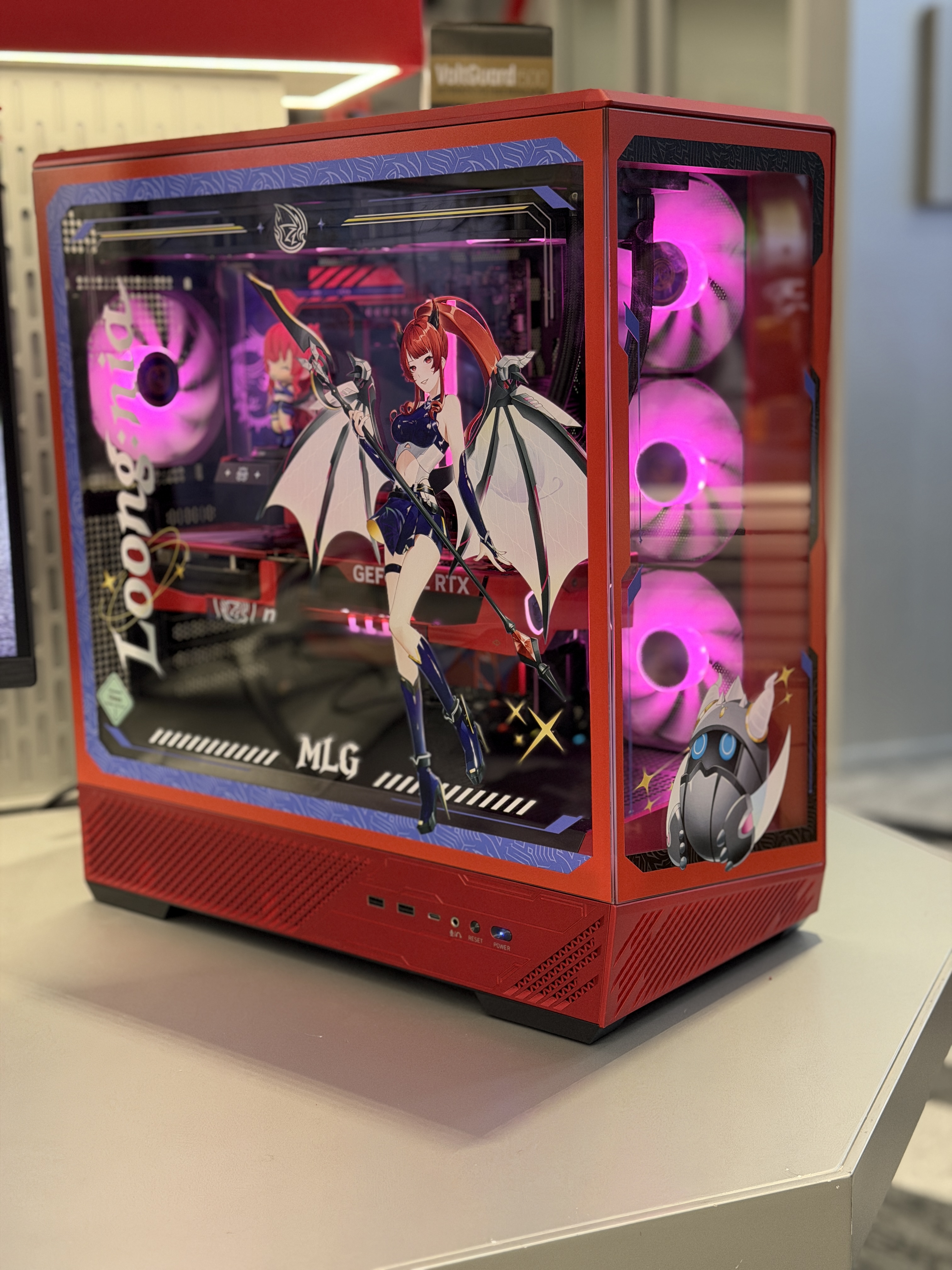 Red gaming PC case with tempered glass panel showing internal RGB lighting